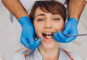 A woman receiving a dental cleaning procedure.